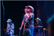 Man in a Cowboy Hat Singing Soulfully Into the Microphone